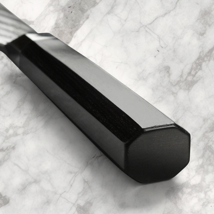 Razor Sharp AZ Shun Dual Core Santoku knife featuring an ebony-colored octagonal PakkaWood handle on marble surface