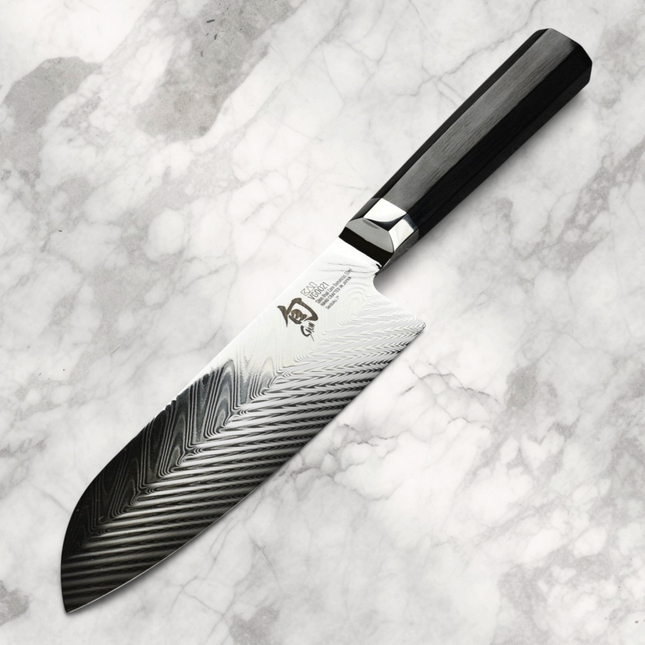 Razor Sharp AZ Shun Dual Core 7-inch Santoku knife with a herringbone blade and black octagonal PakkaWood handle.