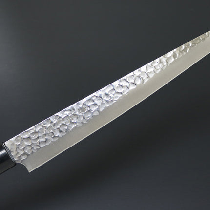 Kanetsune KC-959 Sujihiki carbon 240mm chef knife with hammered tsuchime blade and wooden handle.