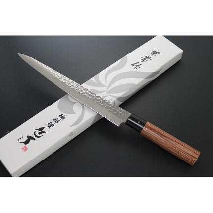 KC-959 Sujihiki Carbon 240mm Kanetsune chef knife with hammered blade and wooden handle on box.