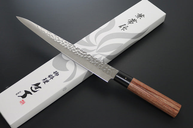 KC-959 Sujihiki Carbon 240mm Kanetsune chef knife with hammered blade and wooden handle on box.