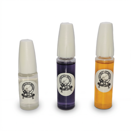 Razor Sharp AZ Gunny Glide graphene lubricant bottles in clear, purple, and amber, featuring precision applicator caps.