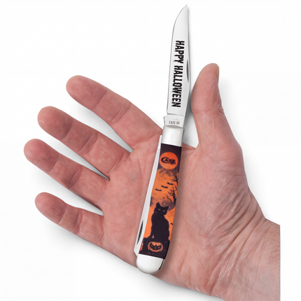 Razor Sharp AZ Case Halloween Color Infusion Trapper knife with black cat and jack-o-lantern handle in a hand