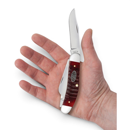 Razor Sharp AZ Case Gator Jigged Old Red Bone Sowbelly pocket knife held in a hand with mirror-polished steel blades
