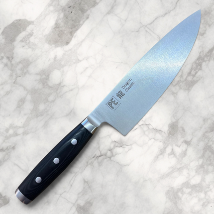 Razor Sharp AZ Perfect Edge Cutlery Dragon Classic 8-inch chef knife with black Micarta handle on wooden board