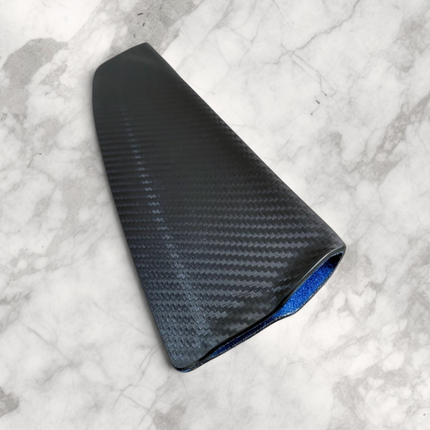 Razor Sharp AZ carbon fiber knife sheath with blue interior lining resting on a natural wood block
