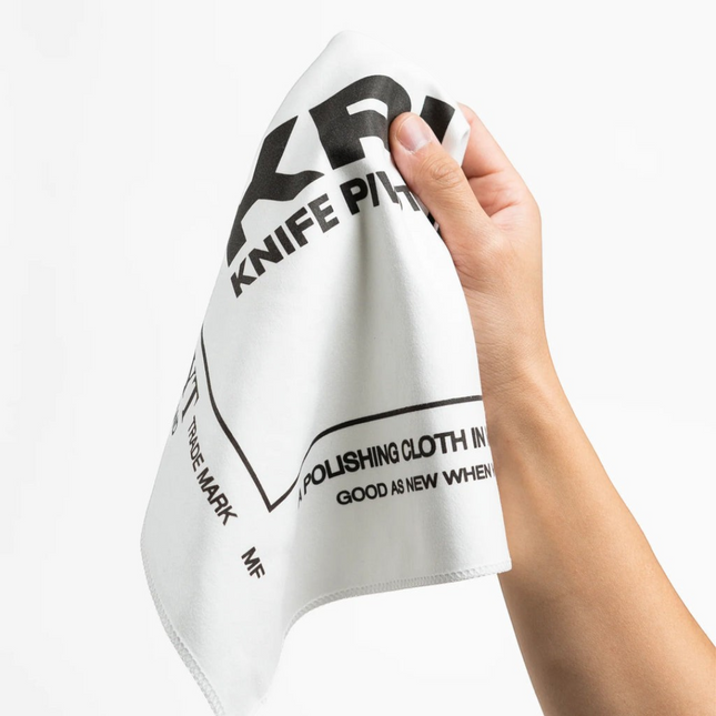 Razor Sharp AZ KPL Selvyt MF white microfiber polishing cloth held in hand for cleaning knives and precision tools