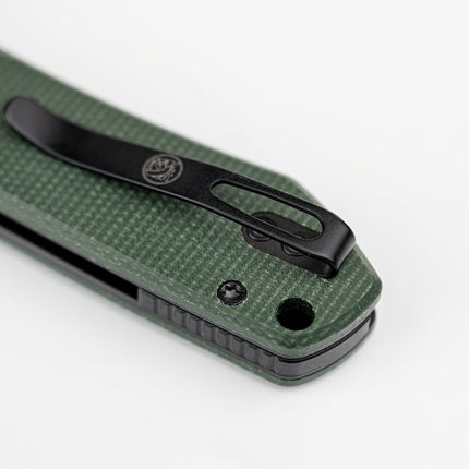 Raccoon 2.0 Top Liner Lock knife with green Micarta handle and black pocket clip.