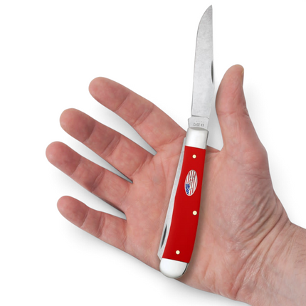 Razor Sharp AZ Case American Workman trapper knife with a red synthetic handle and carbon steel blades held in a hand.