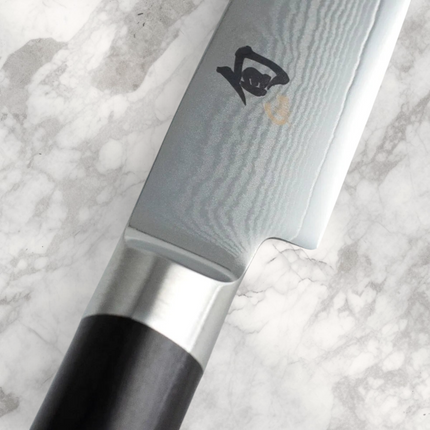 Razor Sharp AZ Shun Classic 4-inch paring knife featuring a Damascus steel blade and black Pakkawood handle.