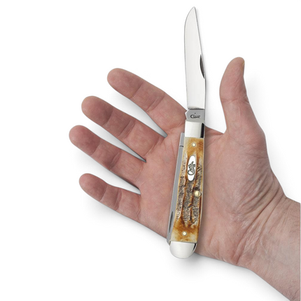 Razor Sharp AZ Case 6.5 BoneStag Trapper knife with jigged amber bone handle held in a hand