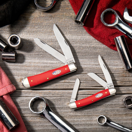 Razor Sharp AZ Case American Workman red synthetic handle stockman knives with carbon steel blades on a workshop table