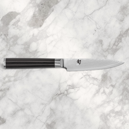 Razor Sharp AZ Shun Classic 4-inch paring knife with a Damascus steel blade and black ebony Pakkawood handle.