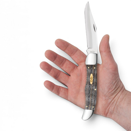 Razor Sharp AZ Case folding hunter knife with black curly oak handle and stainless steel blade held in a hand