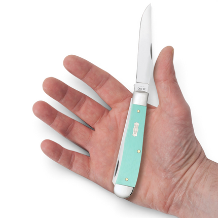 Razor Sharp AZ Case Trapper knife with seafoam green G-10 handle and Ichthus shield held in a palm