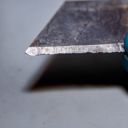 Razor Sharp AZ blade sharpening service shows a close-up of a dull, serrated utility knife blade.