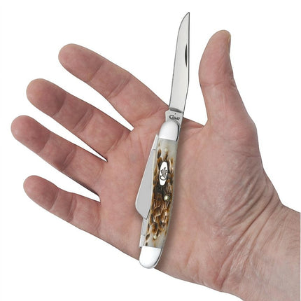 Razor Sharp AZ Case Medium Stockman knife with peach seed jig amber bone handle held in a person's hand