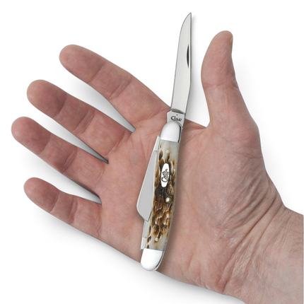 Razor Sharp AZ Case Medium Stockman knife with peach seed jig amber bone handle held in a person's hand