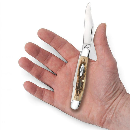 Razor Sharp AZ Case Amber Bone Stockman knife with peach seed jig handle held in a hand with one blade open