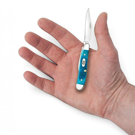 Razor Sharp AZ Case Peanut knife with Caribbean blue sawcut jig bone handle and polished steel blades held in a hand