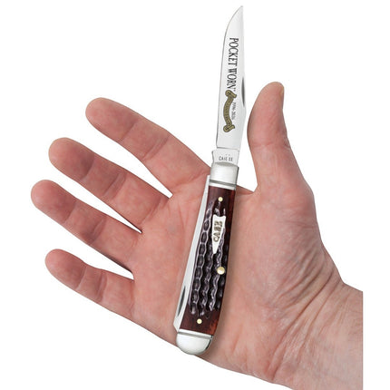 Razor Sharp AZ Case Trapper pocket knife with mahogany bone handle and embellished blade held in a hand