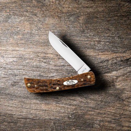 Razor Sharp AZ Case Sod Buster Jr pocket knife with a carbon steel skinner blade and peach seed jig amber bone handle.