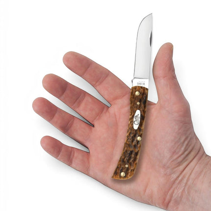 Razor Sharp AZ Case Sod Buster Jr knife with peach seed jig amber bone handle and carbon steel blade held in hand
