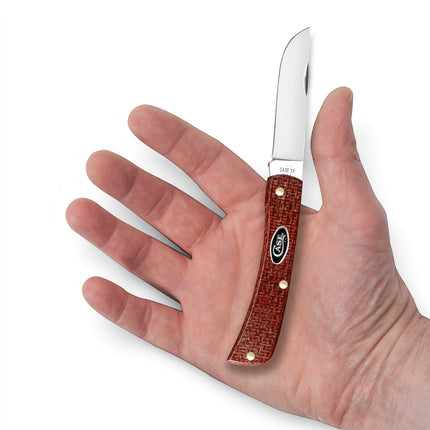 Razor Sharp AZ Case Sod Buster Jr pocket knife with dark red burlap micarta handle held in a person's palm