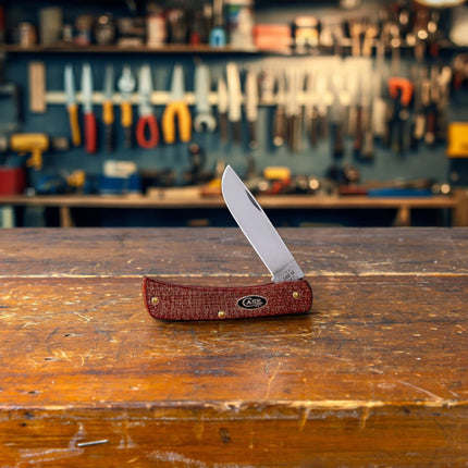 Razor Sharp AZ Case Sod Buster Jr pocket knife with a dark red burlap micarta handle and mirror-polished carbon blade.