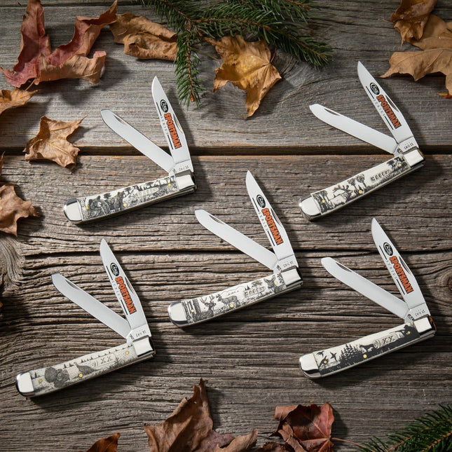 Razor Sharp AZ Case Sportsman Series Trapper knives with deer-embellished natural bone handles on a rustic wood surface.