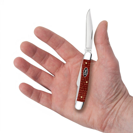 Razor Sharp AZ Case Medium Stockman pocket knife with a dark red burlap Micarta handle held in a person's palm