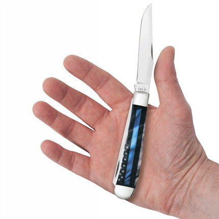 Razor Sharp AZ Case Trapper knife with Stripes of Service blue line flag design held in a hand