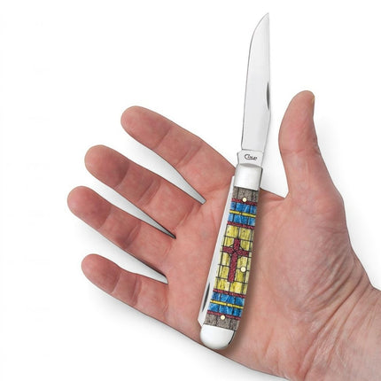 Razor Sharp AZ Case Trapper knife with smooth natural bone handle featuring a stained glass cross design in hand