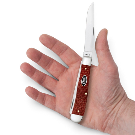 Razor Sharp AZ Case Trapper knife with dark red burlap Micarta handle and polished carbon steel blades held in hand