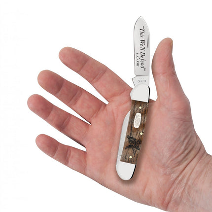 Razor Sharp AZ Case U.S. Army Canoe pocket knife with smooth natural curly oak handle held in a hand