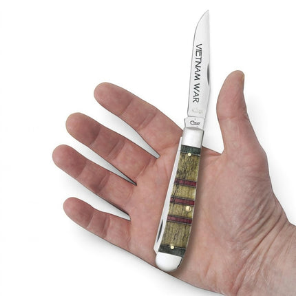 Razor Sharp AZ Case Vietnam War commemorative trapper knife with smooth natural bone handle in a hand
