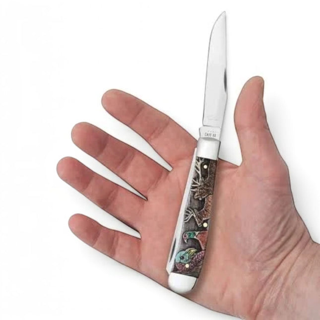 Razor Sharp AZ Case Wild Game Series Trapper knife with engraved natural bone handle held in a hand