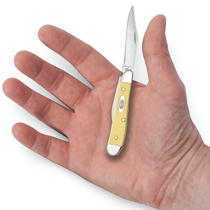 Razor Sharp AZ Case yellow synthetic peanut pocket knife with carbon steel blade held in a palm for scale