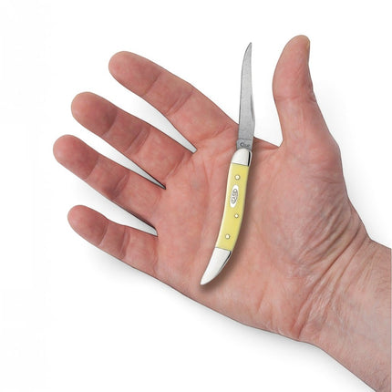 Razor Sharp AZ Case Small Texas Toothpick knife with a yellow synthetic handle and carbon steel clip blade in a hand.