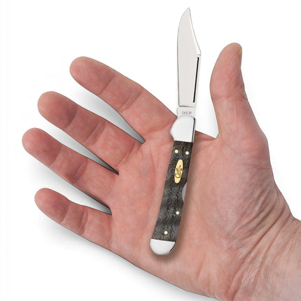 Razor Sharp AZ Case Mini CopperLock pocket knife with smooth black curly oak wood handle held in an open palm