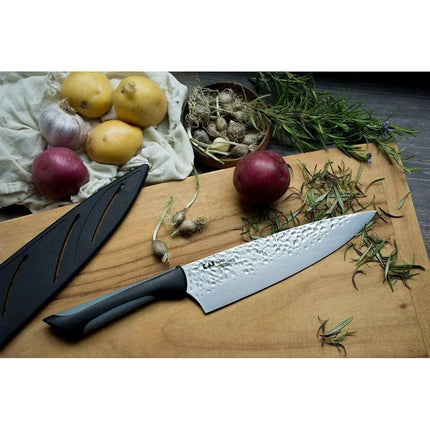 Razor Sharp AZ Kai Luna 8" chef's knife with hammered steel blade and ergonomic handle, next to potatoes, garlic, and rosemary.