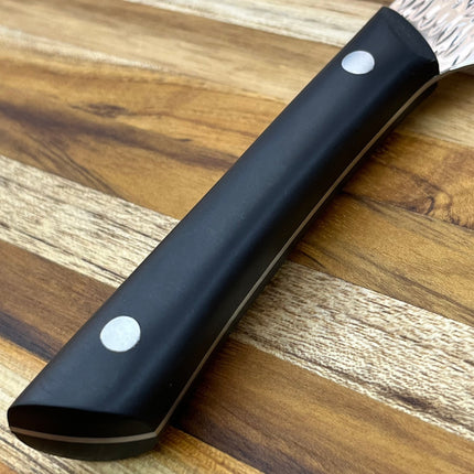 Razor Sharp AZ Kai Pro 6" Nakiri knife with hammered stainless steel blade and black POM handle on a wooden cutting board.