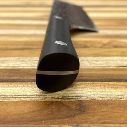 Razor Sharp AZ Kai Pro 6" Nakiri knife with hammered stainless steel blade and black POM handle on a wooden cutting board.