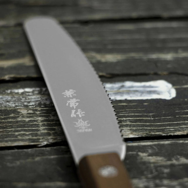Razor Sharp AZ Kanetsune serrated spread knife with stainless steel blade and Kebony maple handle on rustic wood