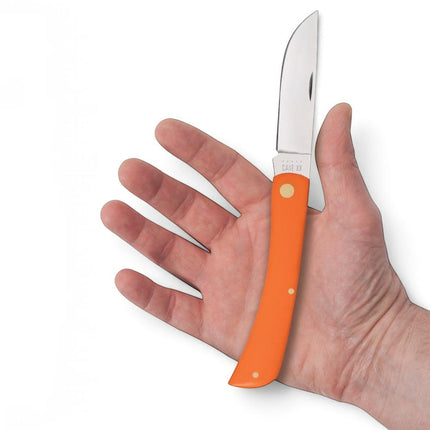 Razor Sharp AZ Case Orange Synthetic Sod Buster folding knife with a mirror-polished stainless steel blade in hand