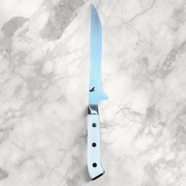 Razor Sharp AZ Perfect Edge Shiro Hane 6-inch boning knife with a white Corian handle on a wooden cutting board