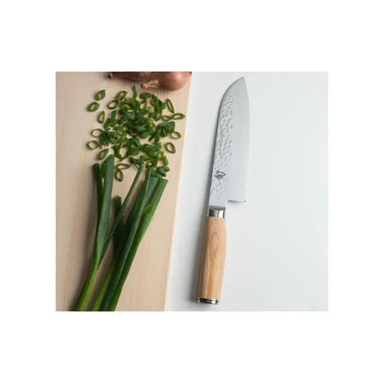 Razor Sharp AZ Shun Premier Blonde 7-inch Santoku knife with hammered blade and blonde PakkaWood handle next to scallions