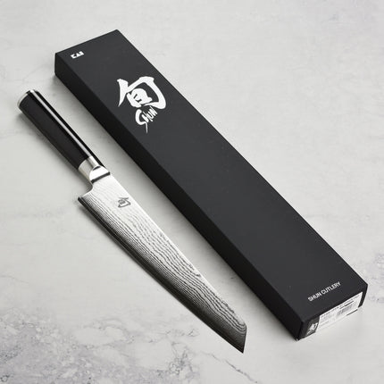 Razor Sharp AZ Shun Classic 9" Master Prep Knife with Damascus blade and black PakkaWood handle.