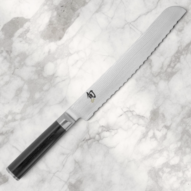 Razor Sharp AZ Shun Classic 9-inch bread knife with serrated Damascus steel blade and black ebony PakkaWood handle.