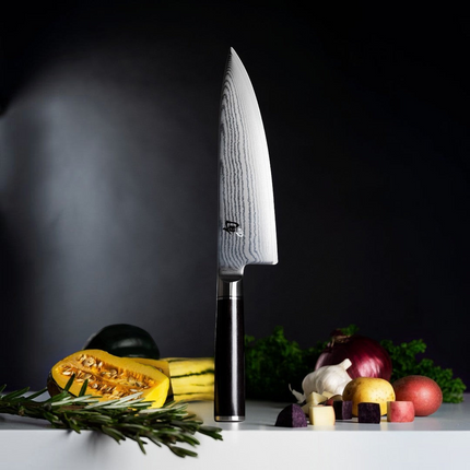 Razor Sharp AZ Shun Classic 8-inch chef's knife with Damascus steel blade and black PakkaWood handle on kitchen counter
